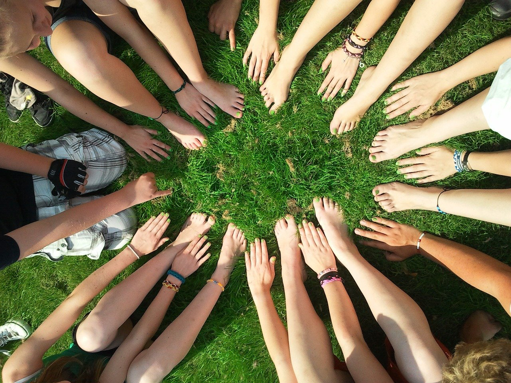 Circle of hands in the grass